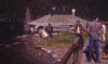 The gang at Hebgen Lake.  Duff Gold's daughters are down by the water's edge. Bob Lanning is on the roof in a red jacket and wearing a white cowboy hat. Nancy Mariella [Rice University] is the girl sitting on the railing.