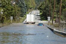 Road under water with vehicles